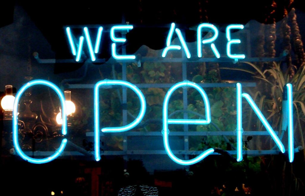 neon sign saying WE ARE OPEN